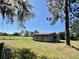 Exterior view of a weathered barn set on a verdant pasture under a clear sky at 19726 Mccall Rd, Altoona, FL 32702
