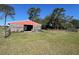 Exterior of the wooden barn set on expansive green land with a clear blue sky at 19726 Mccall Rd, Altoona, FL 32702