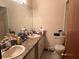 Bathroom vanity with double sinks, and toilet at 19726 Mccall Rd, Altoona, FL 32702