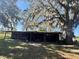 Open-air barn is situated on a lovely lot featuring mature trees at 19726 Mccall Rd, Altoona, FL 32702