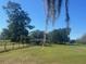 Expansive front yard with mature trees and lush green grass provides a serene and inviting atmosphere at 19726 Mccall Rd, Altoona, FL 32702