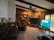 Living room featuring a stone fireplace, ceiling fan, and sliding glass doors at 19726 Mccall Rd, Altoona, FL 32702