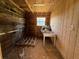 Interior of a wood framed tack room with a window, table, and rustic charm at 19726 Mccall Rd, Altoona, FL 32702
