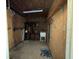 Interior of a basic tack room including sink, shelves, and concrete floor at 19726 Mccall Rd, Altoona, FL 32702