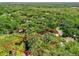 Aerial view highlighting property lines, pond, and wooded area, showcasing the home's unique natural setting at 2010 Otters Pond Rd, Fruitland Park, FL 34731