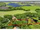 Expansive aerial view showcases the property's lush acreage, water features, and surrounding landscape at 2010 Otters Pond Rd, Fruitland Park, FL 34731