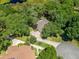 High-angle view of home with large lot and long driveway, surrounded by mature trees at 2010 Otters Pond Rd, Fruitland Park, FL 34731