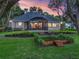 Expansive backyard with screen porch, patio, well-manicured lawn and tiered garden area at 2010 Otters Pond Rd, Fruitland Park, FL 34731