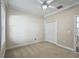 Bedroom features neutral walls, carpet, and closet for storage at 2010 Otters Pond Rd, Fruitland Park, FL 34731