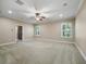 Spacious carpeted bedroom with neutral walls, ceiling fan, recessed lights, and two windows at 2010 Otters Pond Rd, Fruitland Park, FL 34731
