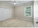 Neutral bedroom with a window, closet, and ceiling fan at 2010 Otters Pond Rd, Fruitland Park, FL 34731