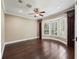 Spacious bedroom features bay windows with plantation shutters and hardwood flooring at 2010 Otters Pond Rd, Fruitland Park, FL 34731
