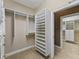 Walk-in closet features custom shelving and hanging rods to maximize storage space at 2010 Otters Pond Rd, Fruitland Park, FL 34731