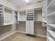 Walk-in closet features custom shelving, hanging rods and built-in drawers at 2010 Otters Pond Rd, Fruitland Park, FL 34731
