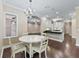 Cozy dining room adjacent to kitchen with hardwood floors and chandelier lighting at 2010 Otters Pond Rd, Fruitland Park, FL 34731