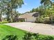 Home with a large driveway, two-car garage and well-manicured lawn at 2010 Otters Pond Rd, Fruitland Park, FL 34731