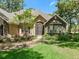Gorgeous single Gathering home has stone details, manicured landscaping and a sidewalk to the front door at 2010 Otters Pond Rd, Fruitland Park, FL 34731