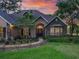 Attractive single Gathering home boasts manicured lawn, walkway, mature trees and stone accents at 2010 Otters Pond Rd, Fruitland Park, FL 34731