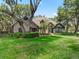 Attractive single Gathering home boasts manicured lawn, mature trees, walkway and stone accents at 2010 Otters Pond Rd, Fruitland Park, FL 34731