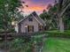 Well-maintained home exterior featuring lush landscaping, elegant lamp post, and stone detailing at 2010 Otters Pond Rd, Fruitland Park, FL 34731