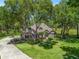 Attractive single-story house showcasing lush front yard, mature trees, a long driveway, and welcoming entrance at 2010 Otters Pond Rd, Fruitland Park, FL 34731