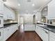 Bright kitchen features white cabinets, dark countertops, and stainless steel appliances at 2010 Otters Pond Rd, Fruitland Park, FL 34731