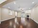 Open living room with hardwood floors, archways, fireplace, and backyard view at 2010 Otters Pond Rd, Fruitland Park, FL 34731