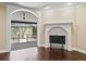 Bright living room showing fireplace and view to screened-in patio with hardwood floors at 2010 Otters Pond Rd, Fruitland Park, FL 34731