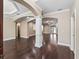 Open concept living room features hardwood floors, columns and large windows for plenty of light at 2010 Otters Pond Rd, Fruitland Park, FL 34731