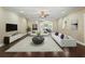 Beautiful living room with hardwood floors, elegant furniture, and a view of the dining room at 2010 Otters Pond Rd, Fruitland Park, FL 34731