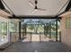 Cozy screened patio with brick floors and ceiling fan at 2010 Otters Pond Rd, Fruitland Park, FL 34731