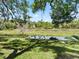 Scenic view of a tranquil pond and expansive backyard, perfect for nature lovers seeking a peaceful retreat at 2010 Otters Pond Rd, Fruitland Park, FL 34731