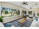Cozy sunroom features hardwood flooring and many windows overlooking the backyard at 2010 Otters Pond Rd, Fruitland Park, FL 34731