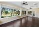 Empty sunroom features hardwood flooring and many windows overlooking the backyard at 2010 Otters Pond Rd, Fruitland Park, FL 34731