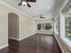 Empty sunroom features hardwood flooring and many windows overlooking backyard at 2010 Otters Pond Rd, Fruitland Park, FL 34731