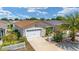 A nice aerial view of a cute single-Gathering home with a two-car garage and mature landscaping at 2095 Thornton Ter, The Villages, FL 32162