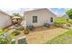 Landscaped backyard featuring a patio, desert plants, and modern exterior at 2095 Thornton Ter, The Villages, FL 32162