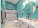 Well-lit bathroom with a white vanity, marble countertops, and a shower-tub combo at 2095 Thornton Ter, The Villages, FL 32162