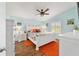 Well-lit bedroom with white furniture, decorative pillows, and a ceiling fan at 2095 Thornton Ter, The Villages, FL 32162