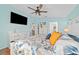 Bright bedroom with a decorative ceiling fan, a TV, and natural light from windows at 2095 Thornton Ter, The Villages, FL 32162