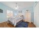 Charming bedroom with hardwood floors, natural light, and beach-themed decor at 2095 Thornton Ter, The Villages, FL 32162