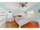 Inviting bedroom with neutral walls, a ceiling fan, and a window providing natural light at 2095 Thornton Ter, The Villages, FL 32162