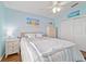 Bright bedroom featuring pale blue walls, wood flooring, and a cozy bed at 2095 Thornton Ter, The Villages, FL 32162