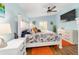 Comfortable bedroom with a ceiling fan and a view of the natural light from the windows at 2095 Thornton Ter, The Villages, FL 32162