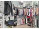 Spacious walk-in closet with shelving and hanging rods, great for organization at 2095 Thornton Ter, The Villages, FL 32162