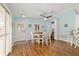 A well-lit dining room with wood floors, natural light, and light blue walls is perfect for entertaining at 2095 Thornton Ter, The Villages, FL 32162