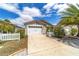 Attractive home featuring a two-car garage, well-manicured landscaping, and a long driveway at 2095 Thornton Ter, The Villages, FL 32162