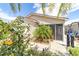 Charming home with flowering shrubs, a cute palm tree and a screened in lanai at 2095 Thornton Ter, The Villages, FL 32162