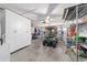 Spacious garage with a golf cart, storage cabinets, and wire shelving at 2095 Thornton Ter, The Villages, FL 32162