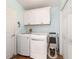 Efficient laundry room with appliances, storage cabinets, and easy access at 2095 Thornton Ter, The Villages, FL 32162